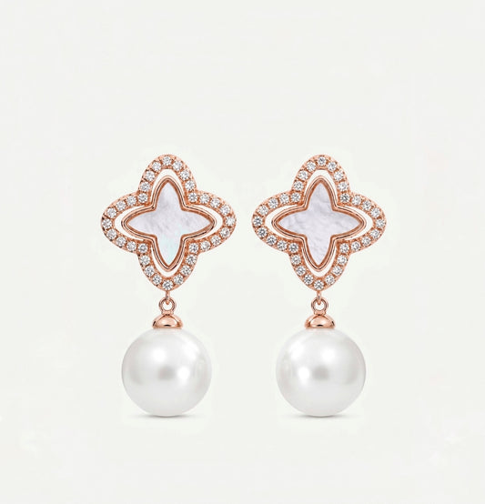 Rose gold clover-shaped earrings with white inlay, small diamonds, and hanging white pearls.