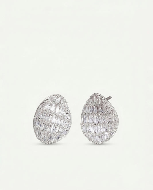 Pair of silver-tone teardrop-shaped stud earrings with baguette-cut clear stones on a dark burgundy background