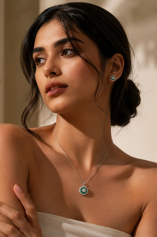 925 sterling silver emerald necklace and matching stud earrings on a woman