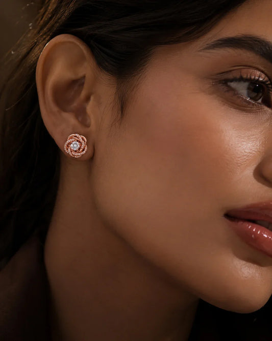 Woman wearing PEHRO 925 Sterling Silver Rose Gold Plated Knot Stud Earrings
