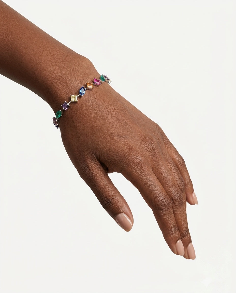 Close-up of a woman's wrist wearing the 925 Sterling Silver Multicolor Station Bracelet, styled for modern everyday wear