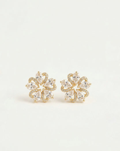 A pair of gold flower-shaped stud earrings set with clear marquise-cut and round gemstones, displayed on a clean white background.