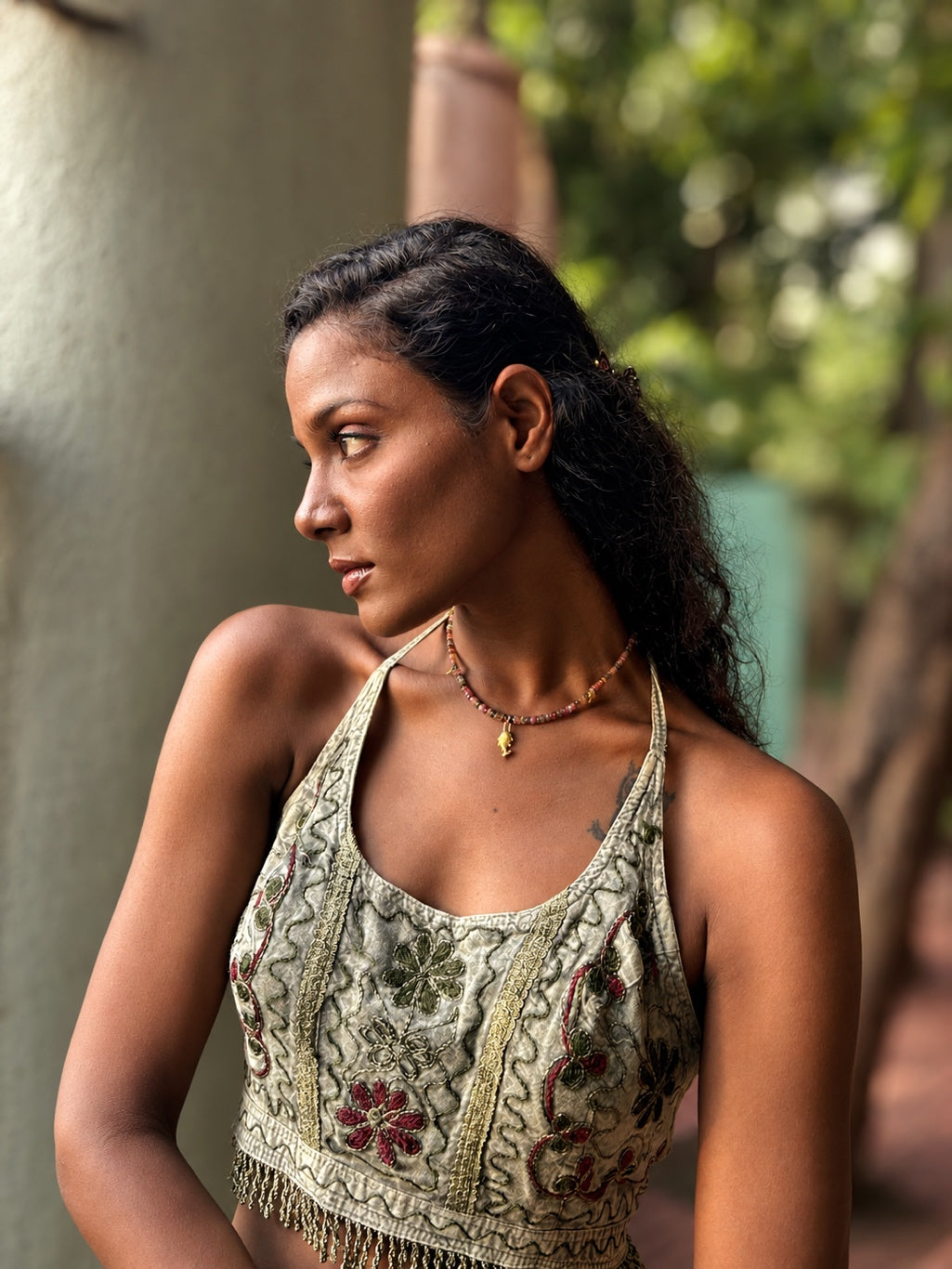 Saatrangi multi tourmaline charm choker necklace worn around the neck, showing adjustable extension clasp