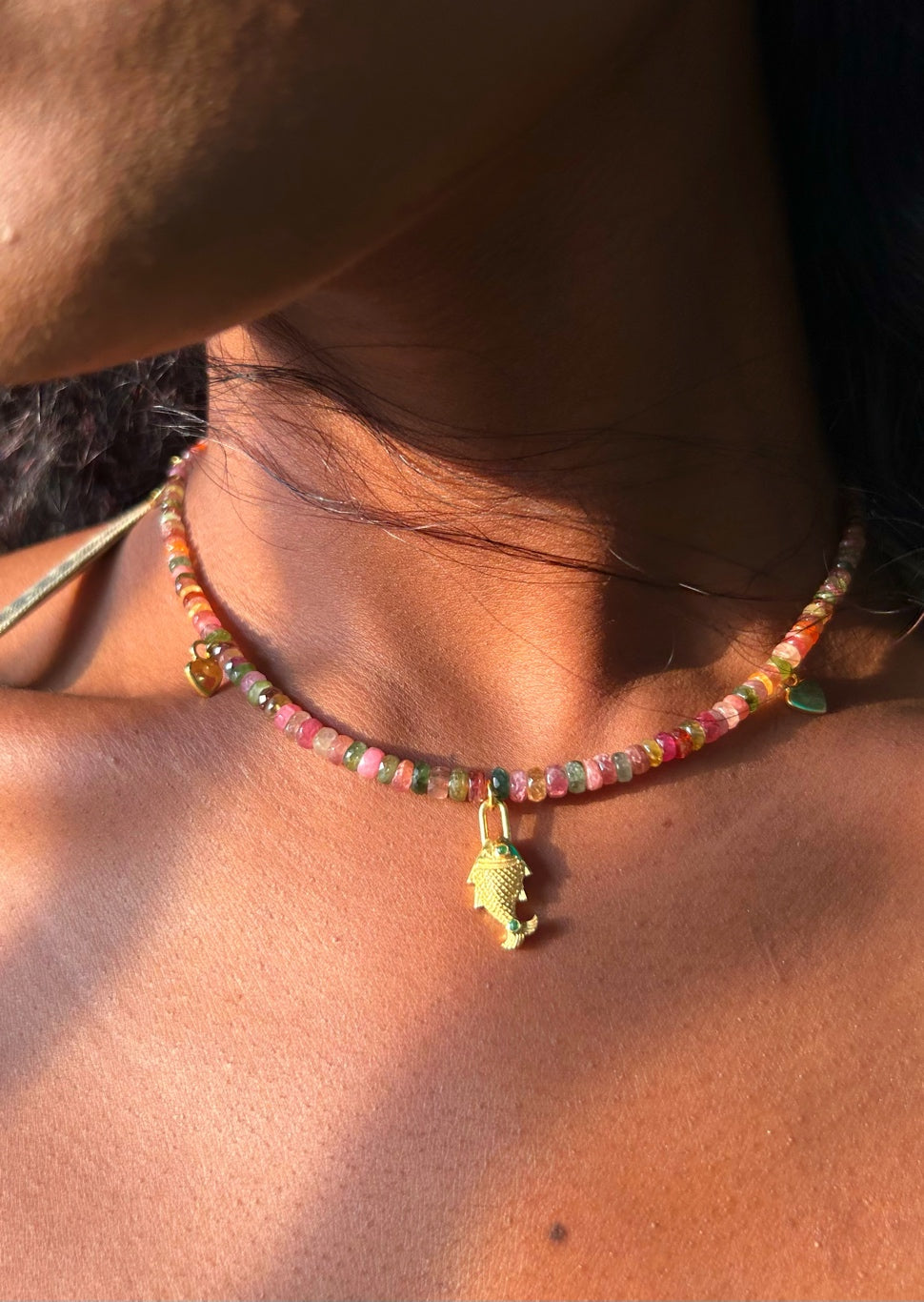 Close-up of natural multi tourmaline rondelle beads in pink, green, gold and plum on the Saatrangi charm choker necklace