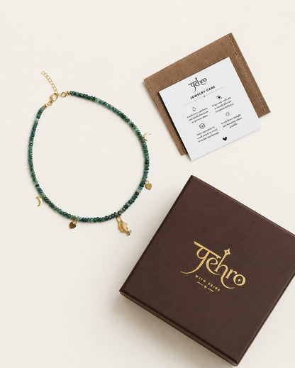 925 sterling silver gemstone necklace with green-blue beads, gold-toned charms, PEHRO jewellery box, and jewellery care card.