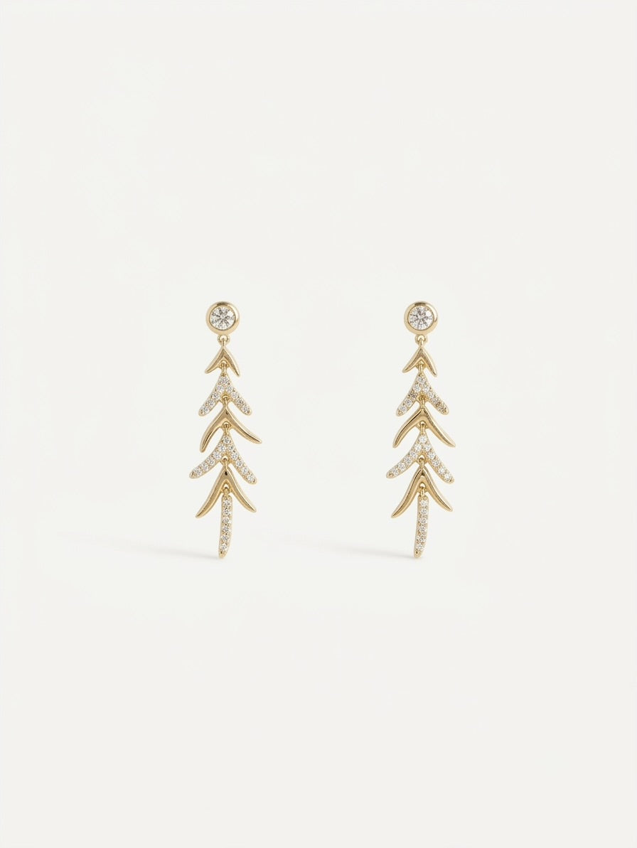 A pair of gold drop earrings with a leaf or branch-like layered design, embellished with small clear stones,