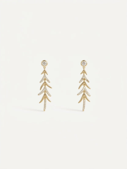 A pair of gold drop earrings with a leaf or branch-like layered design, embellished with small clear stones,
