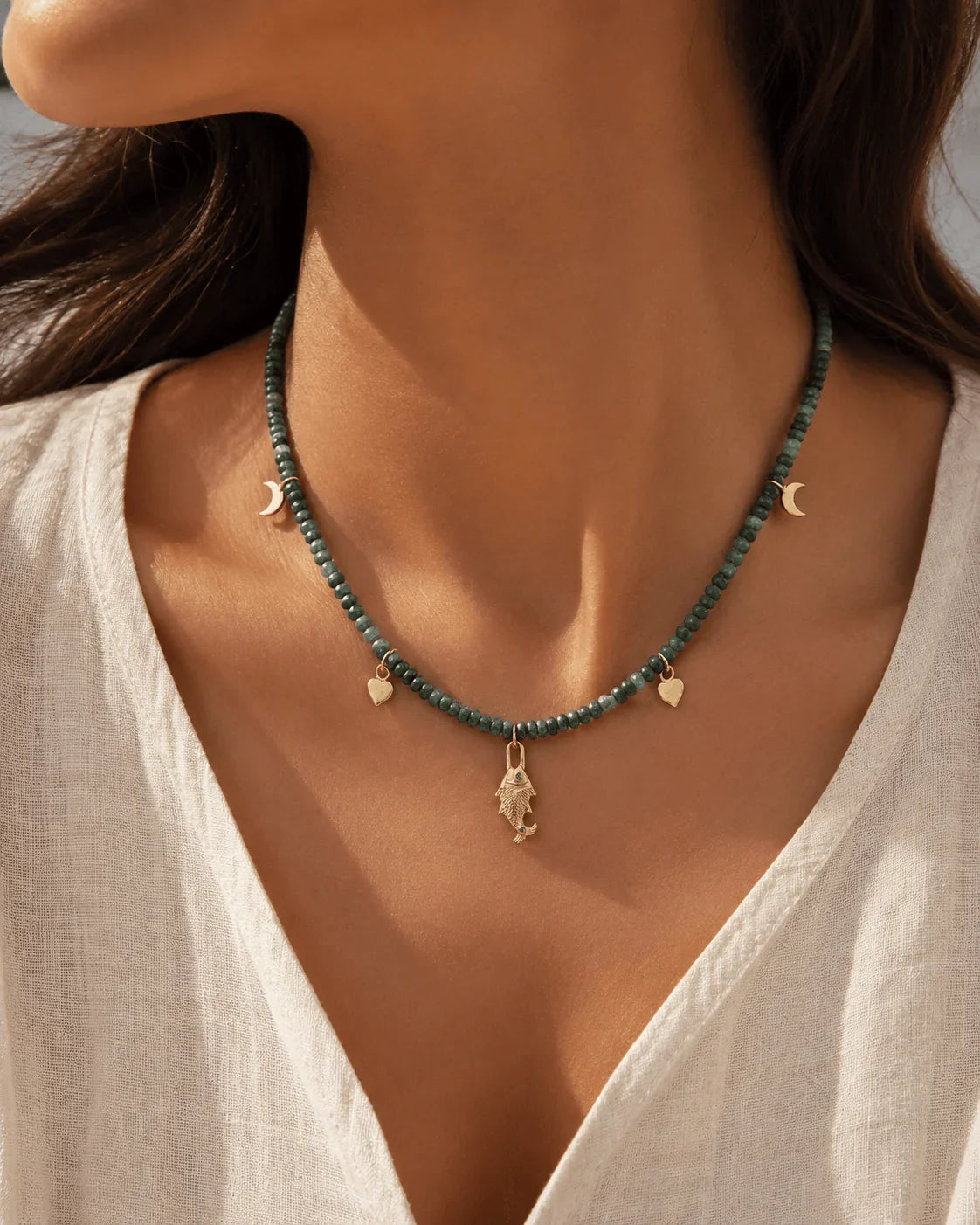 Close-up of natural Grandidierite gemstone beads and fish pendant on PEHRO 925 Sterling Silver choker