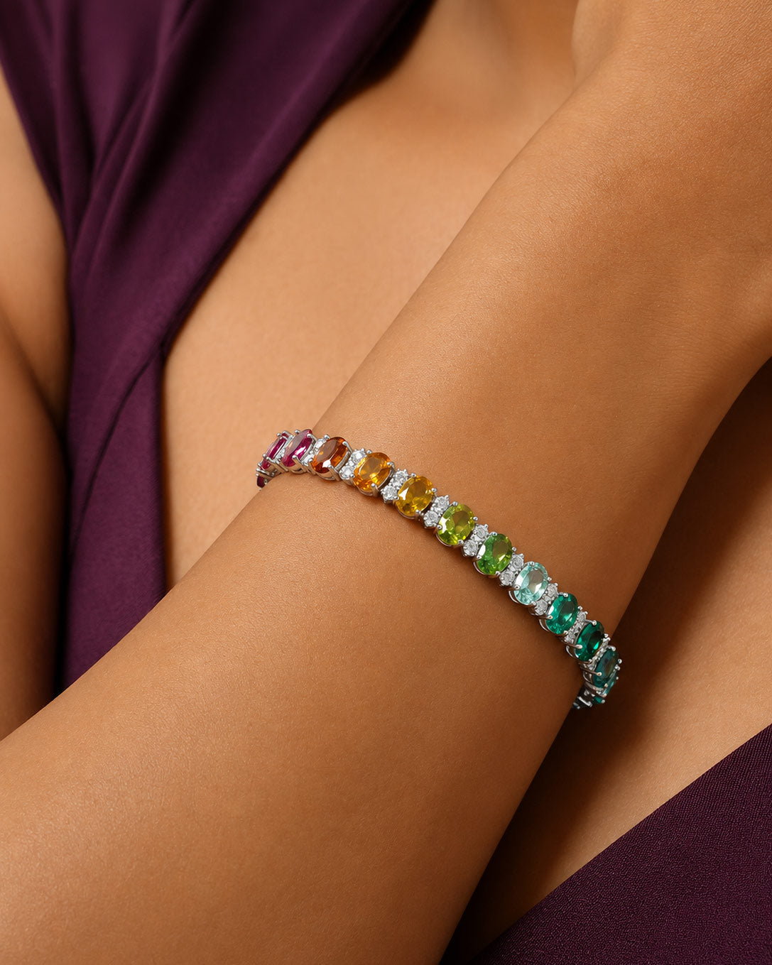 Close-up of the rainbow gradient and brilliant white stones on the PEHRO Tennis Bracelet