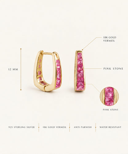 Gold huggie hoop earrings with a channel of pink stones, shown on a light beige background with measurement annotations indicating 12 mm width and 18K gold vermeil and pink stone details.