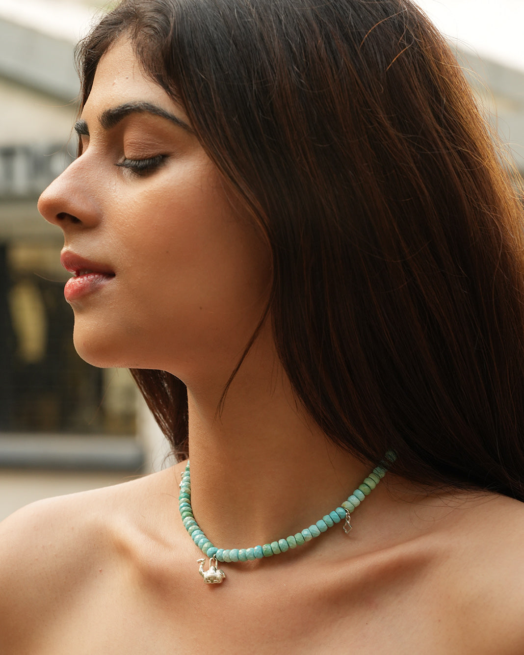 Close-up of woman wearing a natural Arizona turquoise necklace with silver accents