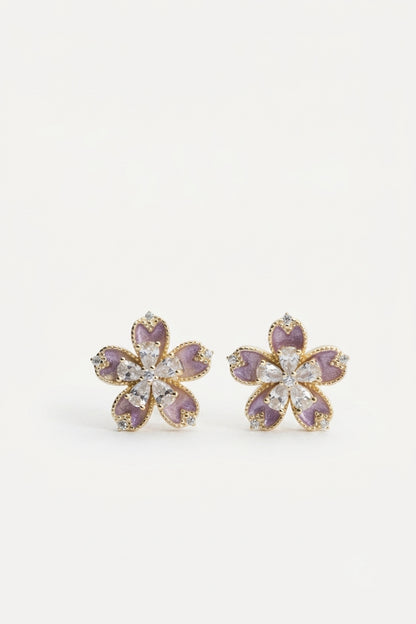 Pair of flower-shaped stud earrings with purple enamel petals and clear stone accents.