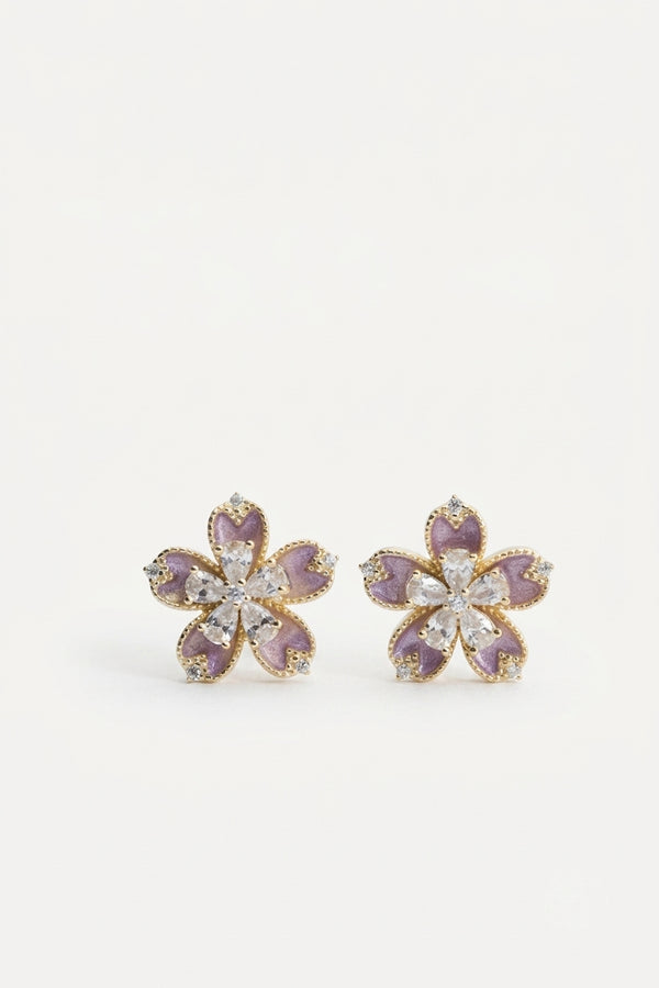 Pair of flower-shaped stud earrings with purple enamel petals and clear stone accents.
