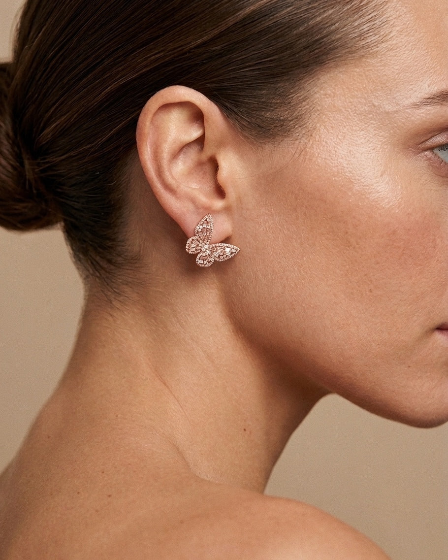 Side profile of a woman elegantly wearing the lightweight 925 Sterling Silver Aurora Butterfly Stud Earrings, showcasing the rose gold finish and everyday wear styling.