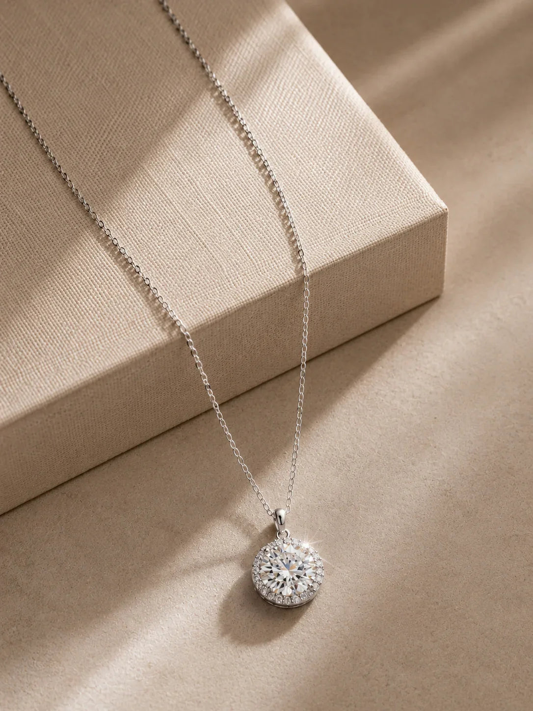 Close-up of the 3 carat round-cut moissanite halo pendant by PEHRO