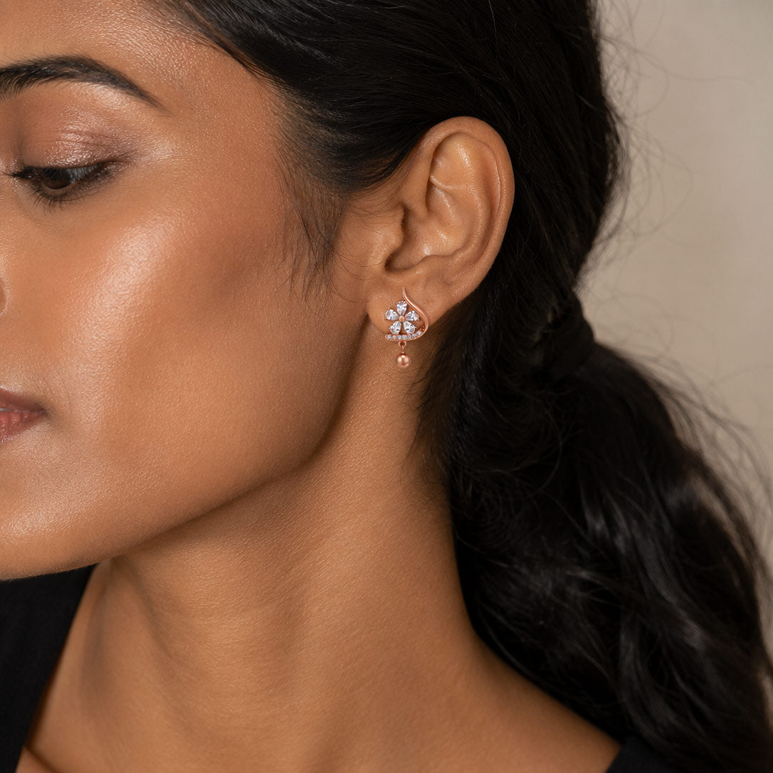 Woman wearing PEHRO 925 Sterling Silver Rose Gold Floral Drop Stud Earrings