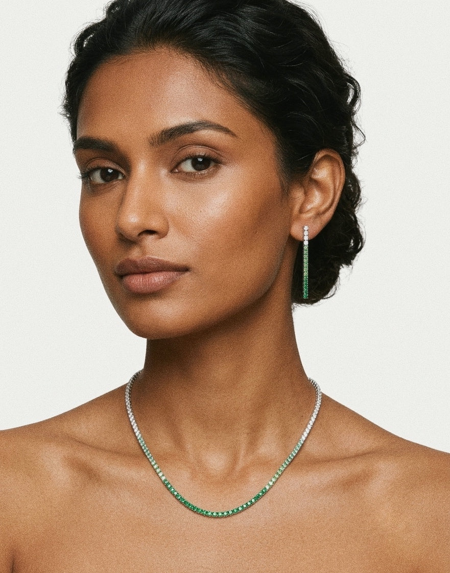 Woman wearing PEHRO 925 Sterling Silver Emerald Tennis Necklace and matching Emerald Drop Earrings
