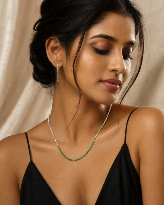 Woman wearing PEHRO 925 Sterling Silver Emerald Tennis Necklace and matching Emerald Drop Earrings