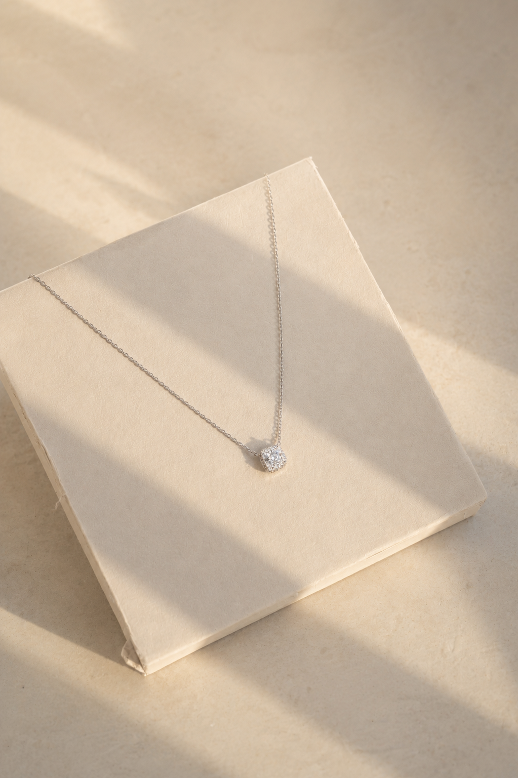 PEHRO Silver Cushion Halo Pendant Necklace styled for an elegant occasion